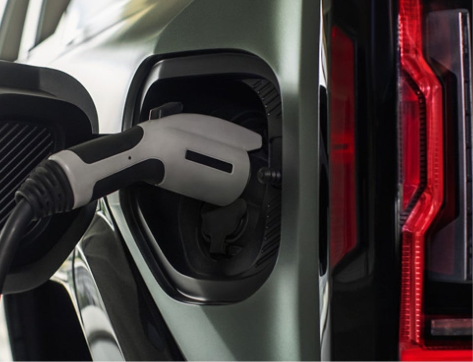 Close up of charging port with charger plugged in on a GMC Hummer EV SUV - Sundance GMC in SAINT JOHNS MI